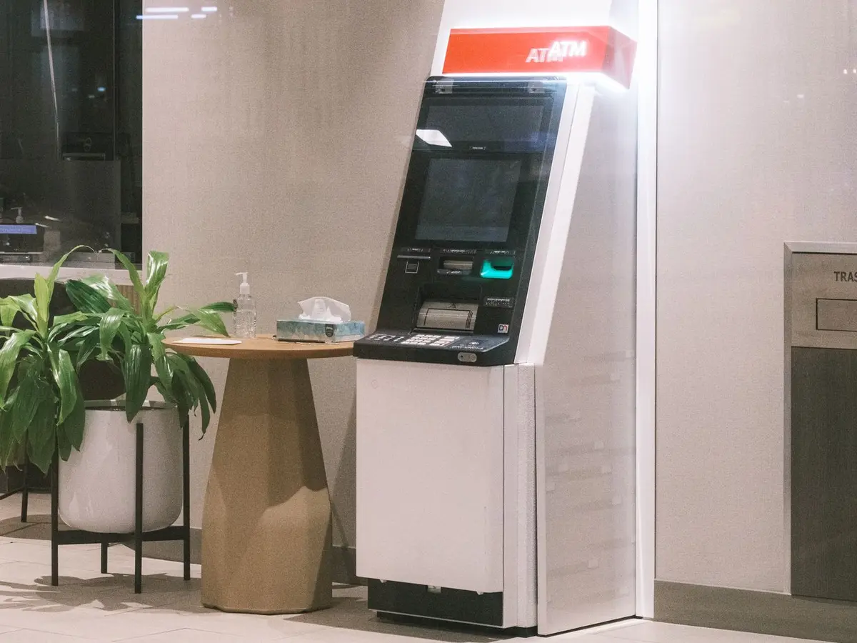 A bank photo: counter, plant and cash machine in a modern branch