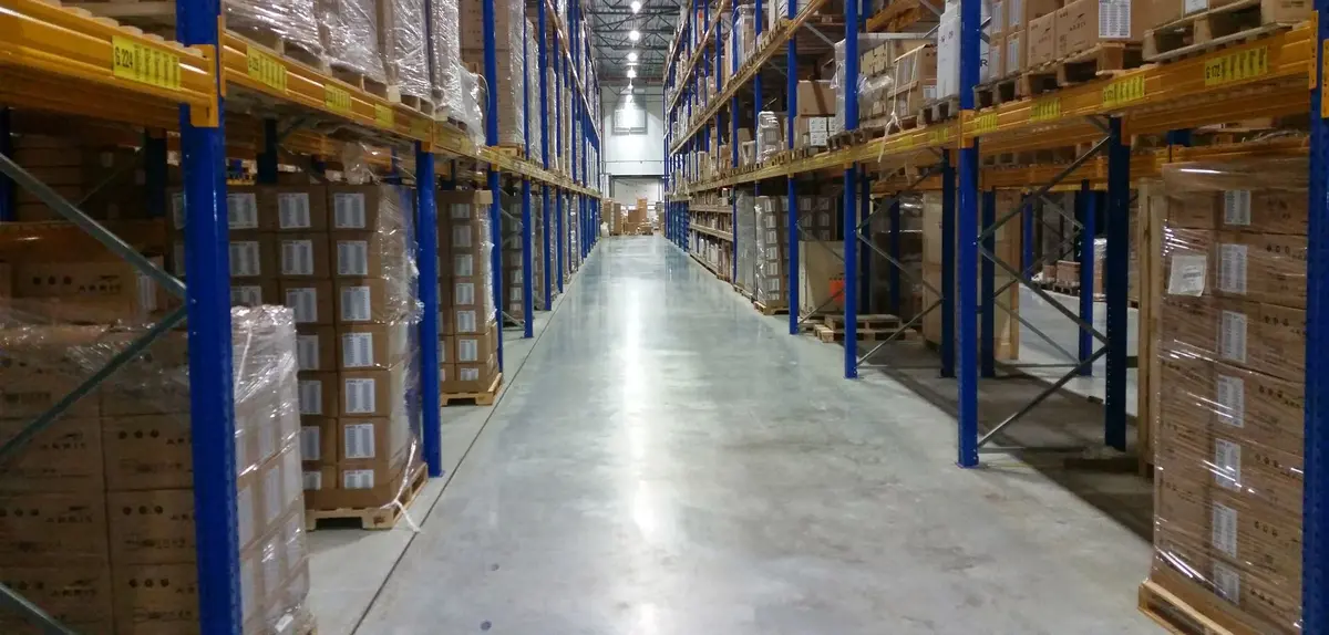 A long warehouse aisle with high shelves