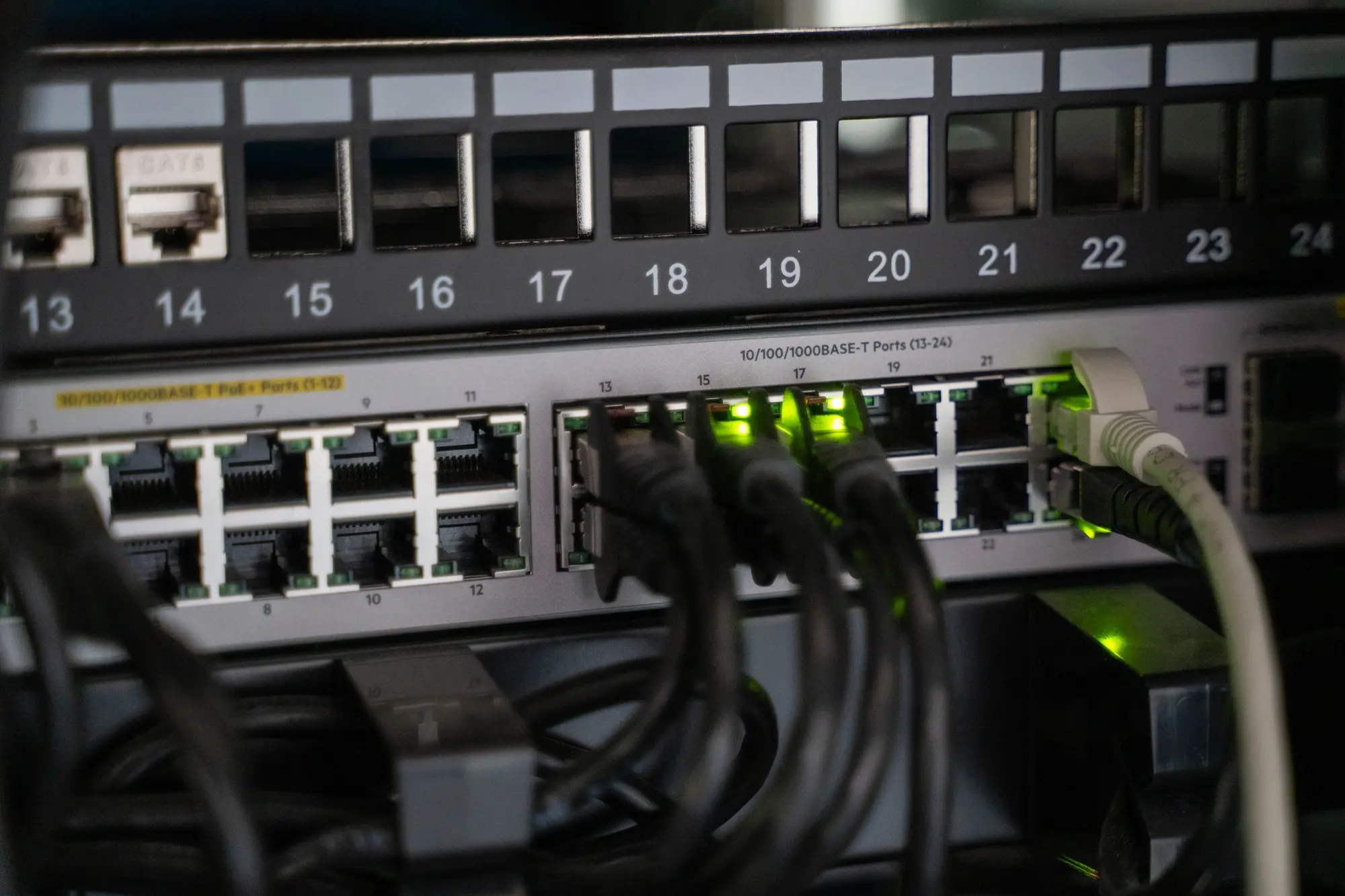 Patch panel above a switch with green link lights